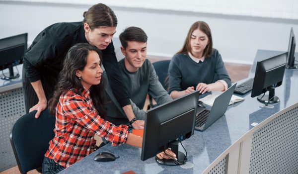 Look at this. Group of young people in casual clothes working in the modern office.